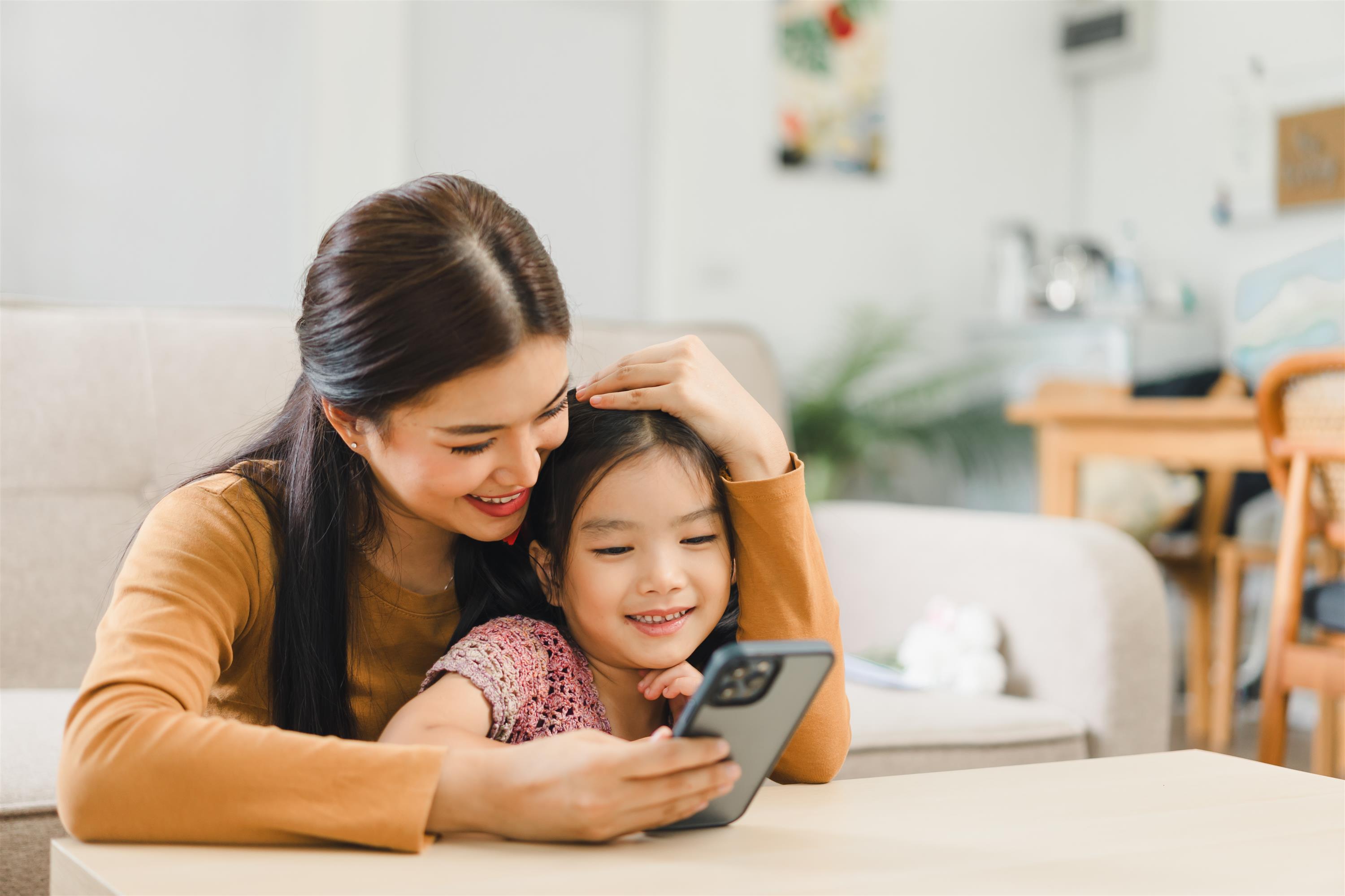 Mom and daughter looking at phone